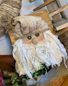 a close up of a statue of an old man wearing a hat and beard on top of a wooden table