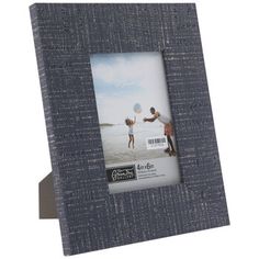 a gray wooden frame with an image of two people on the beach