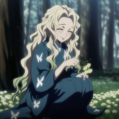 a woman sitting in the grass with long blonde hair and blue dress holding a flower