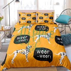 a yellow bed with black and white dalmatian dogs on it's cover