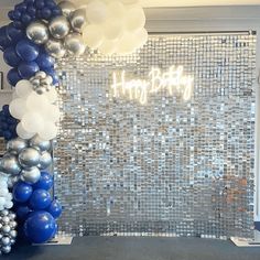 an arch made out of balloons with the words happy birthday written in white and blue