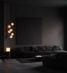 a living room with black couches and lamps on the wall next to a window