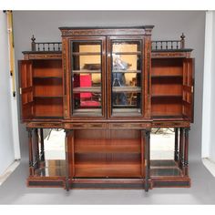 an old wooden bookcase with glass doors