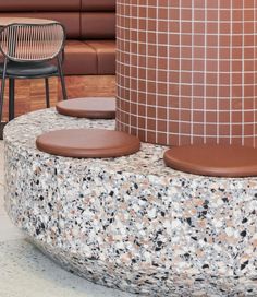 two chairs sitting next to each other on top of a stone bench in front of a building