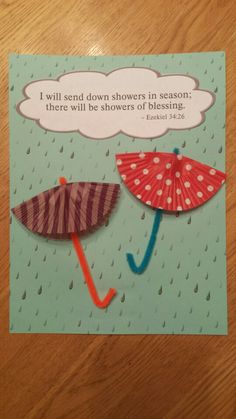 a card with two umbrellas that say i will send down showers in season there will be showers of blessing