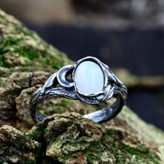 This sterling silver masterpiece is more than just a ring; it's a unique moon flower promise for the woman who appreciates vintage style and the beauty of nature. With its enchanting design and delicate moonstone, this ring captures the essence of a vintage forest wedding.  Characteristics: Metal - Recycled solid sterling silver  Stone - Moonstone Finish - Oxidized. View all silver sun and moon rings: https://www.etsy.com/shop/TinyShinyJewel?ref=seller-platform-mcnav&section_id=44309450 Care instructions: To care for the ring, avoid contact with water and chemicals such as perfumes and lotions. When the ring is not in use, store it in a dry, cool place to prevent tarnishing. Additional information:  ✦ All rings are made to order. An average turnaround time is 1-5 days. I will make every ef Hand Forged Moonstone Ring For Wedding, Mystical Sterling Silver Moonstone Wedding Ring, Moon Shaped Moonstone Wedding Ring, Nature-inspired Moonstone Wedding Ring, Nature-inspired Moonstone Wedding Jewelry, Mystical Handmade Moonstone Wedding Ring, Magical Silver Moonstone Wedding Ring, Moonstone Moon Phase Wedding Jewelry, Magical Moonstone Wedding Rings