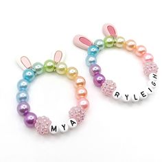 two colorful bracelets with bunny ears and name beads on the front, one is for maybe