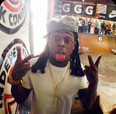 a young man with dreadlocks making a silly face at a skateboard park