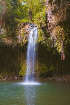 there is a waterfall in the middle of the water and it's cascading