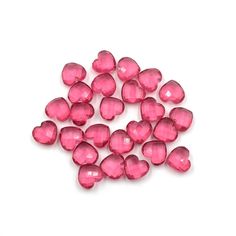 pink heart shaped glass beads on a white background