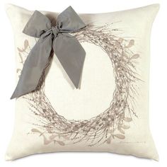 a decorative pillow with a bow on it