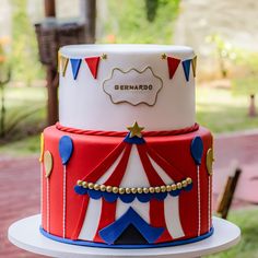 a red and white circus themed cake on a table