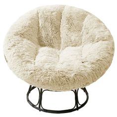 a round chair that is made out of sheepskin and has black metal frame legs