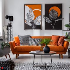 a living room with orange couches and black and white rugs on the floor