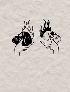 two hands holding a cell phone with flames coming out of the top and one hand holding a skull