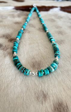 This gorgeous southwestern style necklace was made using genuine Nacozari turquoise free form disk beads and 925 sterling silver beads. Length is 29 1/4" and has a chain for adjustment. $250   Item 159B Silver Heishi Beads Hand-strung Jewelry, Silver Heishi Beads Jewelry Hand-strung, Silver Heishi Bead Jewelry, Artisan Beaded Turquoise Necklace In Sterling Silver, Adjustable Turquoise Necklace With Polished Sterling Silver Beads, Adjustable Turquoise Necklace With Silver Beads, Adjustable Sterling Silver Turquoise Necklace With Polished Beads, Artisan Turquoise Necklace With Polished Sterling Silver Beads, Artisan Sterling Silver Turquoise Necklace With Polished Beads