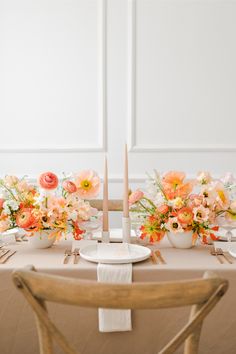 the table is set with flowers and candles