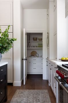 the kitchen is clean and ready for us to use it's white cabinetry