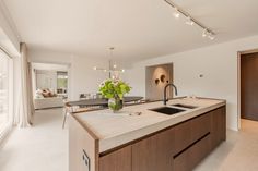 a large kitchen with an island and sink