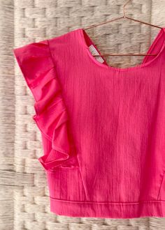 This adorable, cotton blouse with ruffles is made from 100% cotton and fits like a comfy t-shirt. Ties in the back. One size. 19 inches from shoulder to hem, 22 inches across bust. All of our apparel items come packaged in a re-usable, handmade, all natural palm envelope. Pink Ruffle Hem Top For Summer, Summer Ruffle Top With Flutter Sleeves, Summer Tops With Ruffles And Flutter Sleeves, Cotton Ruffle T-shirt With Flutter Sleeves, Pink Ruffle Sleeve Tops For Summer, Cotton T-shirt With Ruffles And Flutter Sleeves, Pink Ruffle Top With Flutter Sleeves, Summer Ruffled Short Sleeve Tops, Summer Ruffle T-shirt With Flutter Sleeves