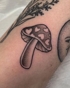 a mushroom with hearts on its head is shown in this tattoo design by the artist