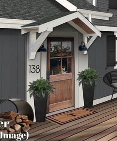 the front porch is painted gray and has potted plants on it, along with an outdoor fireplace