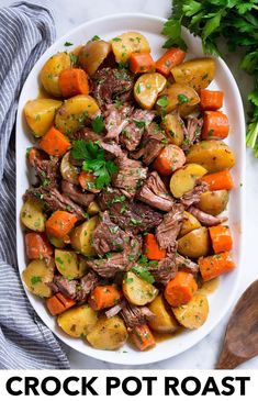 a white platter filled with meat and potatoes next to parsley on the side