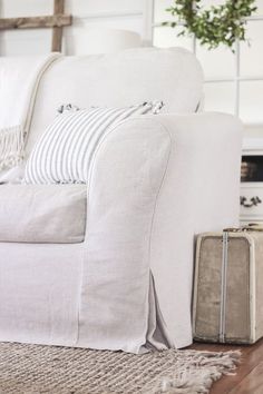 a white couch sitting on top of a wooden floor