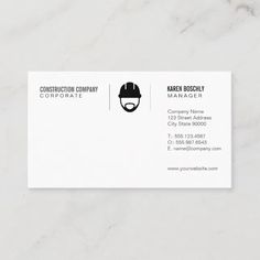 a white business card with a black helmet on the front and bottom, which reads construction company