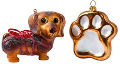 a golden dog ornament with a red ribbon