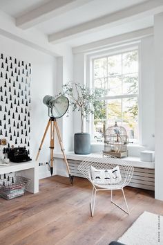 a living room with white walls and wooden floors