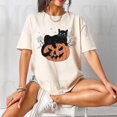 Black Cat Pumpkin, Ghots Cat, Retro Halloween Discover Our Latest Range Of Versatile And Stylish T-Shirts (Gildan 5000), Where Style Harmonizes With Unparalleled Comfort! Featuring Sizes From S To 3xl And A Vibrant Spectrum Of Colors Such As Black, White, Sand, Green, Sport Grey, Red, Navy, And More, There's A Choice To Cater To Every Taste. Crafted With Precision Using Top-Notch Materials, Our T-Shirts Offer A Luxurious Sensation And An Impeccable Fit That Endures Throughout The Day. Engineered White T-shirt With Cat Print For Fall, White Cat Print T-shirt For Halloween, Spooky Cat Design Tops For Fall, White Cat Design Top For Fall, Spooky Fall Tops With Cat Print, Spooky Cat Print Tops For Fall, Fall Cat Print Streetwear Top, Halloween White T-shirt With Cat Print, Cotton Cat Design Top For Fall