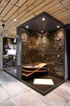 a room with a stone wall and wooden ceiling