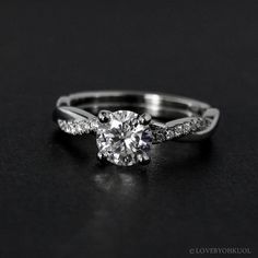 a white gold engagement ring with diamonds on it