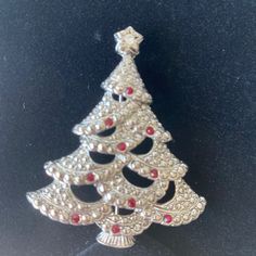 Vintage Avon, Red Crystal Silver Tone Victorian Christmas Tree Brooch Pendant. This Victorian Style Christmas Tree Brooch With Red And Clear Crystal Accents Converts To A Pendant With A Hidden Veil By Avon. It’s Signed And It’s New. It Would Make A Great Addition To Your Holiday Jewelry Collection. Silver Brooches For Christmas Party, Silver Christmas Party Brooch, Silver Christmas Party Brooches, Red Christmas Brooch For The Holidays, Red Christmas Brooch For Holidays, Red Christmas Holiday Brooch, Red Christmas Holiday Brooches, Victorian Style Christmas, Victorian Christmas Tree