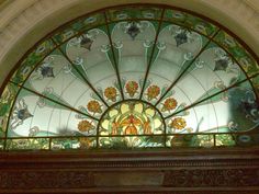 an ornate stained glass window above a doorway