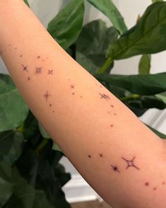 a person's arm with small stars on it