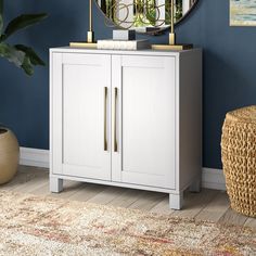 a white cabinet with a round mirror on top and a rug in the corner next to it