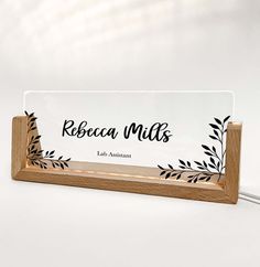 an acrylic sign with the words ribbeca mils on it and leaves