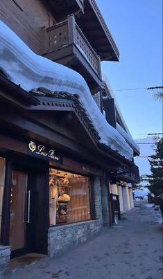 a building with snow on the roof and windows