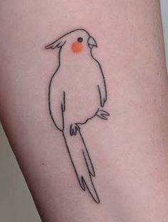 a small black and white bird on the right side of the arm with an orange dot in its beak