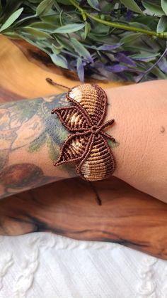 a person with tattoos on their arm wearing a bracelet