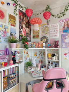 a pink chair sitting in front of a desk with lots of pictures on the wall