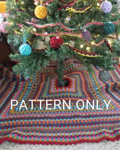 a crocheted christmas tree skirt is on the floor next to a knitted rug