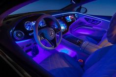 the interior of a car is lit up with blue lights