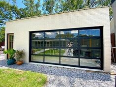 a man is reflected in the windows of a garage