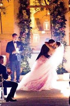 a bride and groom kissing in front of their guests