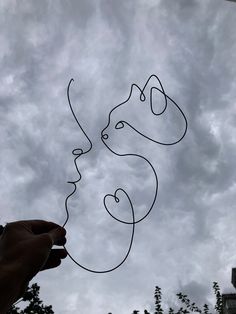 someone is flying a kite in the sky with two faces drawn on it's side