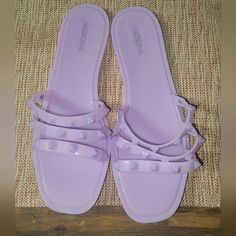 Brand New, Never Worn Casual Purple Sandals For Party, Trendy Purple Sandals For The Beach, Trendy Purple Sandals For Summer, Trendy Purple Sandals For Vacation, Trendy Flat Synthetic Jelly Sandals, Trendy Purple Vacation Sandals, Purple Jelly Sandals For Beach In Spring, Purple Flat Heels For Summer, Trendy Purple Synthetic Sandals