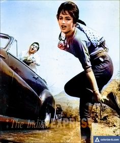 a woman leaning on the hood of a car with another woman in the background behind her